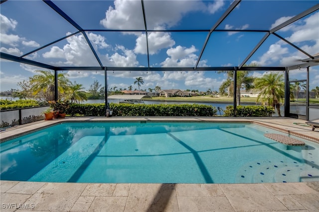 view of pool featuring a water view, glass enclosure, and a patio area