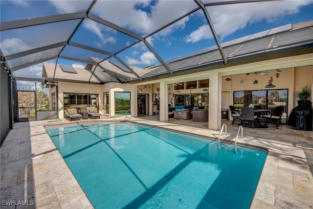 view of swimming pool featuring a lanai and a patio