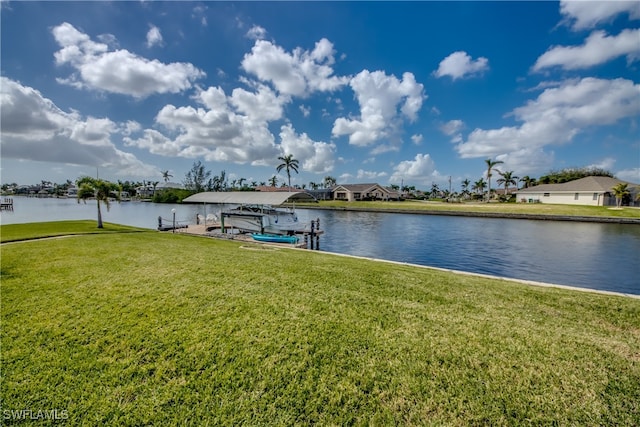 view of dock with a water view and a yard