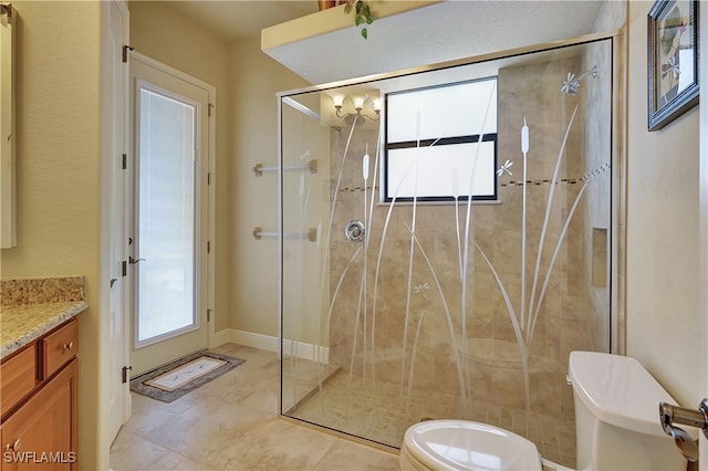 bathroom featuring tile patterned flooring, a shower with door, vanity, and toilet