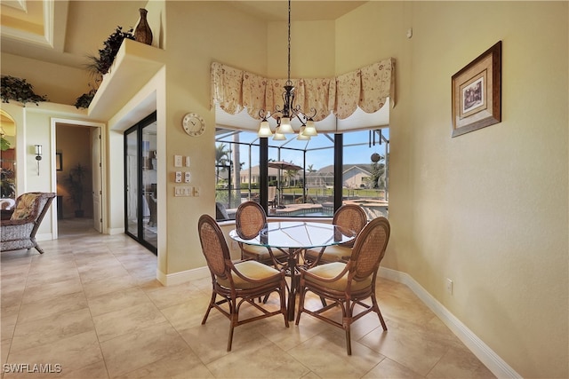 dining space featuring light tile patterned flooring, a high ceiling, and a notable chandelier