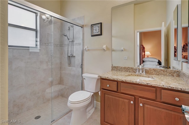 bathroom featuring tile patterned flooring, vanity, toilet, and walk in shower