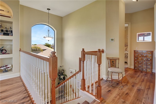 hallway with hardwood / wood-style floors