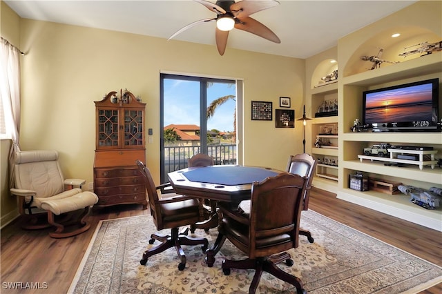 dining area featuring ceiling fan, hardwood / wood-style floors, and built in features