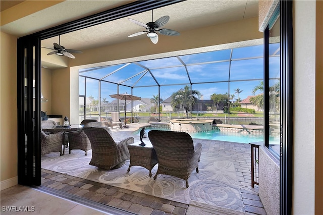 view of patio featuring a pool with hot tub and a lanai