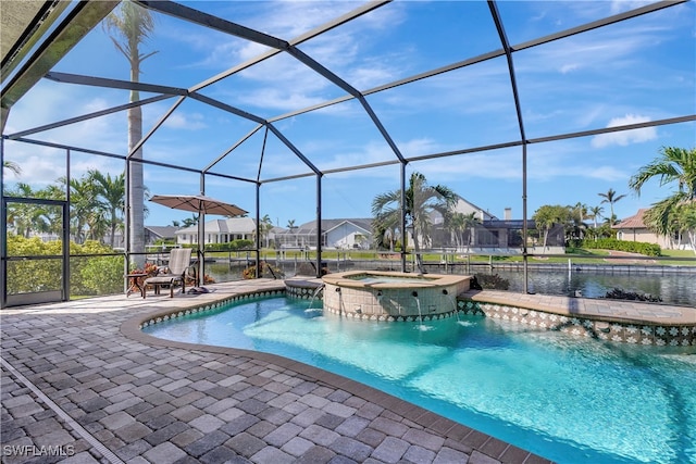 view of swimming pool with glass enclosure, pool water feature, a patio area, an in ground hot tub, and a water view