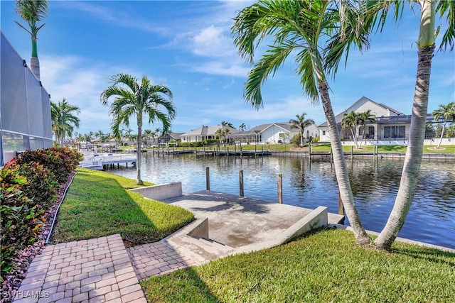 dock area with a yard and a water view