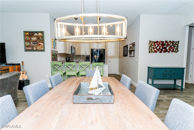dining area featuring dark hardwood / wood-style floors and a notable chandelier