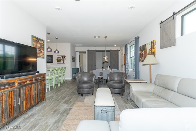 living room with light wood-type flooring and a barn door