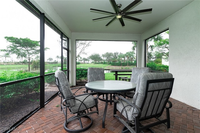 sunroom featuring a healthy amount of sunlight and ceiling fan