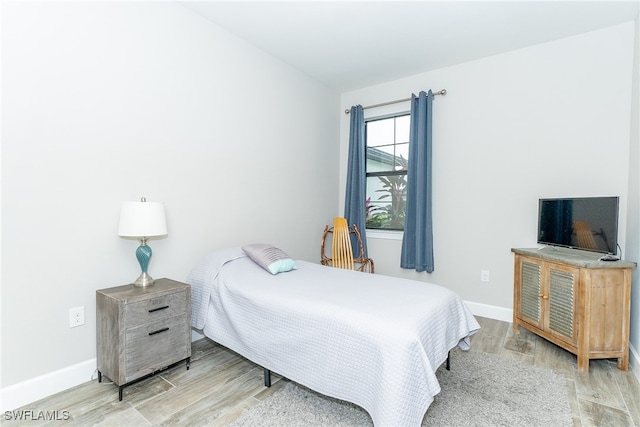 bedroom with hardwood / wood-style flooring