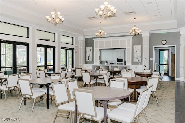 dining room with plenty of natural light, ornate columns, and french doors