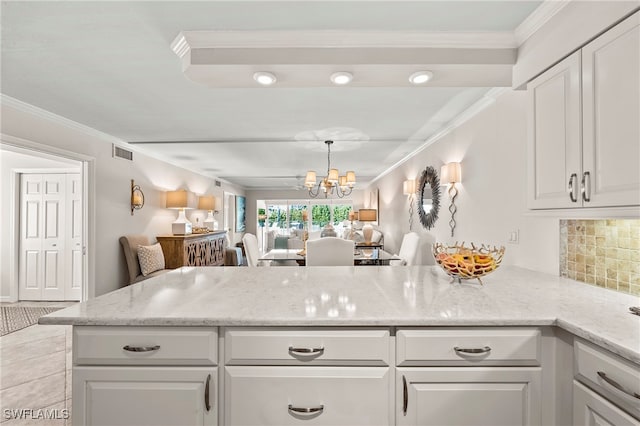 kitchen with white cabinetry and ornamental molding