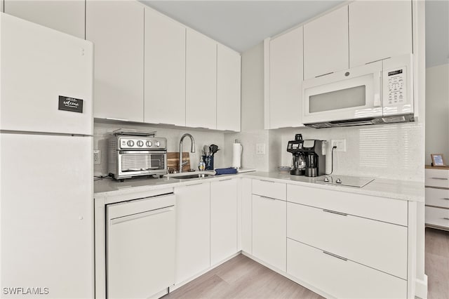 kitchen featuring sink, white appliances, white cabinetry, backsplash, and light wood-type flooring