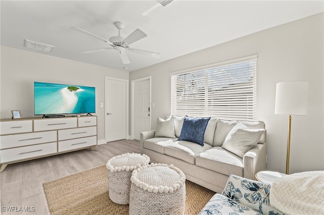 living room with ceiling fan and light hardwood / wood-style flooring