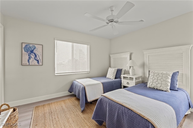 bedroom with ceiling fan and wood-type flooring