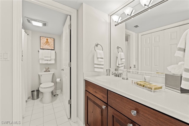 bathroom featuring tile patterned floors, vanity, and toilet