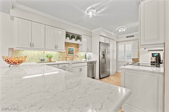 kitchen featuring stainless steel appliances, white cabinetry, ornamental molding, and decorative backsplash