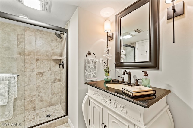 bathroom featuring vanity and a shower with door