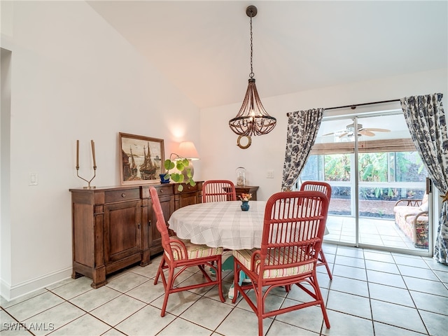 dining space with ceiling fan with notable chandelier, light tile patterned floors, and lofted ceiling