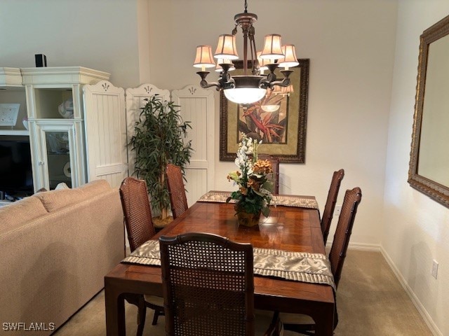 dining area with a notable chandelier and carpet floors