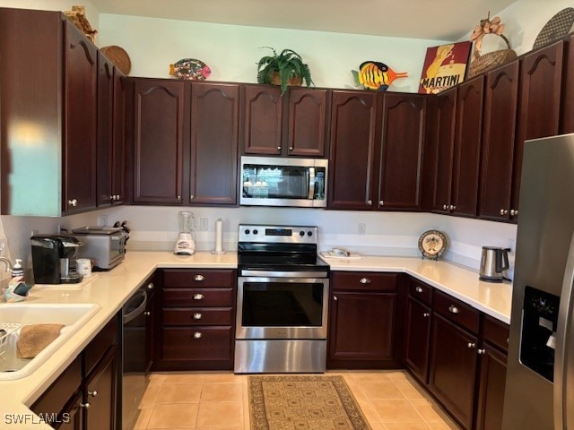 kitchen with sink, light tile patterned floors, and stainless steel appliances