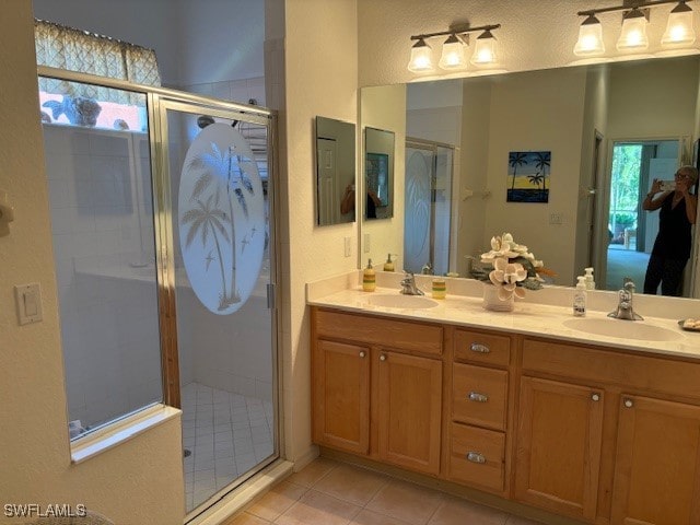 bathroom with vanity, walk in shower, tile patterned flooring, and a healthy amount of sunlight