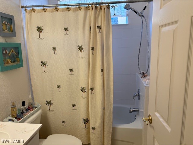 full bathroom with vanity, shower / bath combo with shower curtain, and toilet