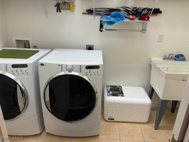 washroom featuring washer and dryer and light tile patterned floors