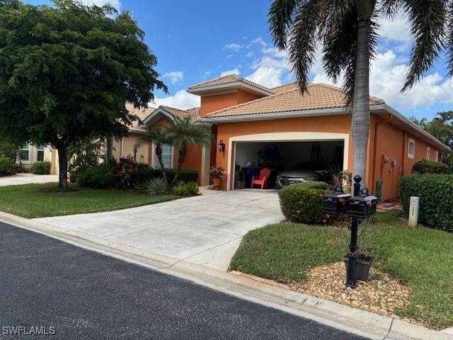 mediterranean / spanish-style home featuring a garage and a front yard