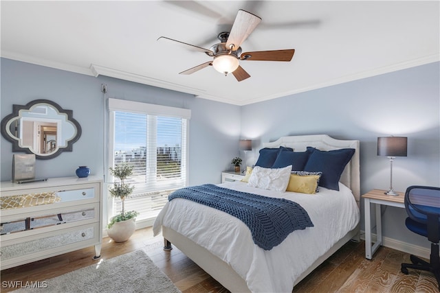 bedroom featuring hardwood / wood-style floors, ceiling fan, and ornamental molding