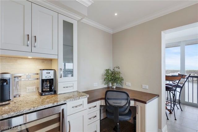 office featuring light tile patterned floors, crown molding, and wine cooler