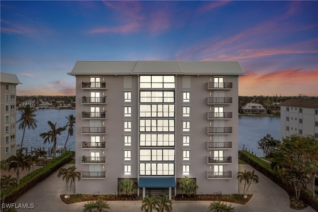 outdoor building at dusk featuring a water view