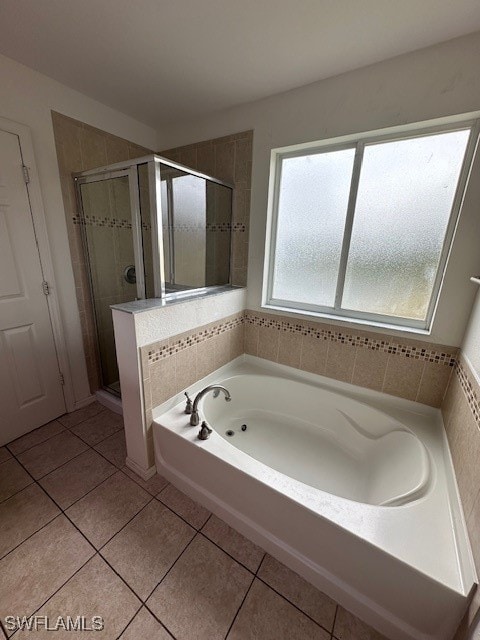 bathroom with shower with separate bathtub and tile patterned floors