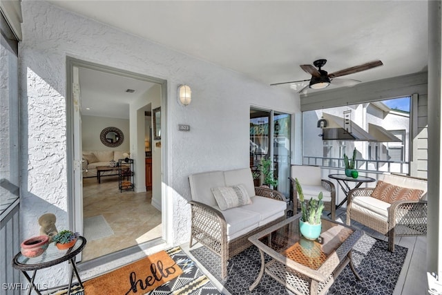 sunroom / solarium featuring ceiling fan