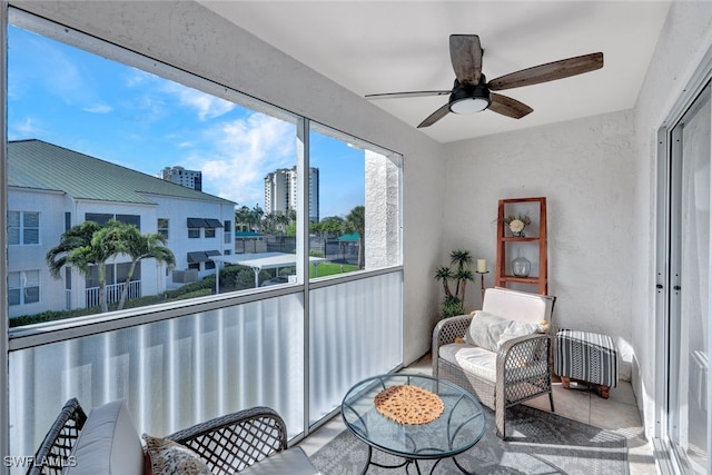 sunroom featuring radiator and ceiling fan