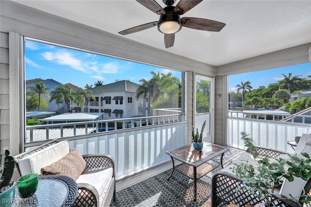 sunroom / solarium featuring ceiling fan