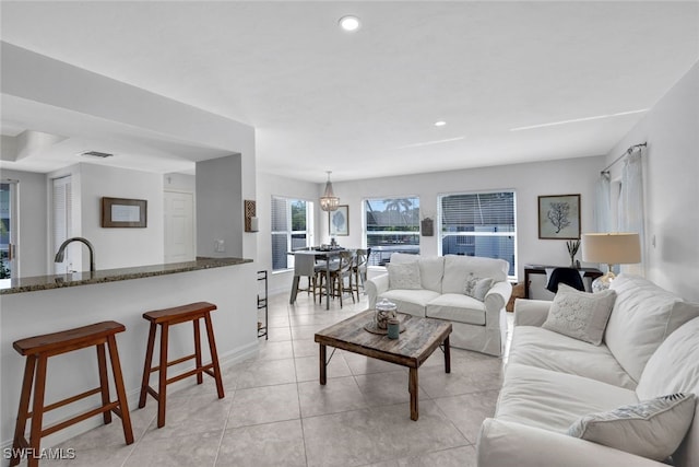 living room with sink and a notable chandelier