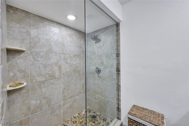 bathroom with tiled shower