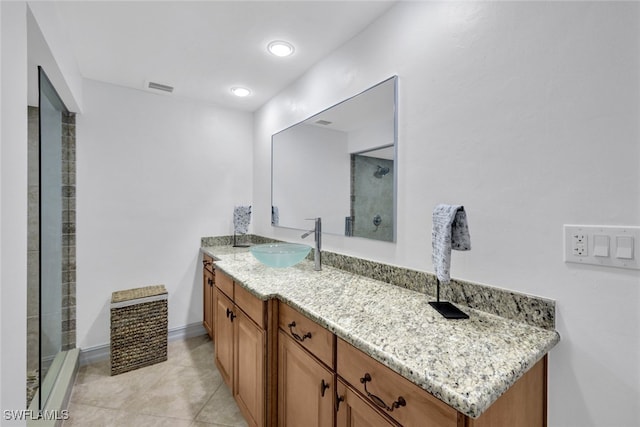 bathroom with vanity, tile patterned floors, and a tile shower