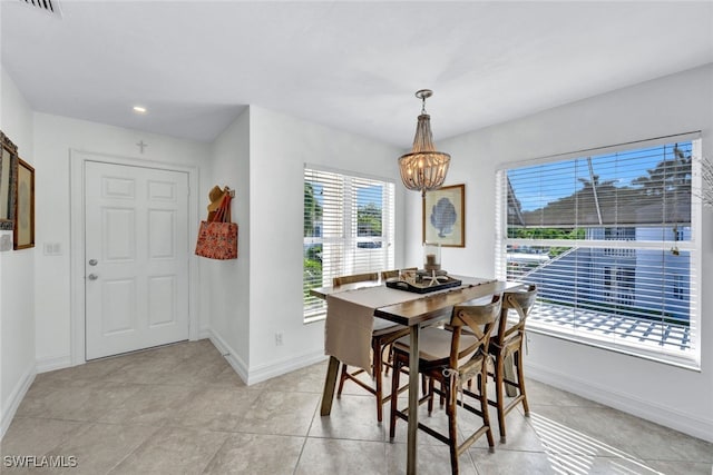 dining space featuring a notable chandelier and light tile patterned floors