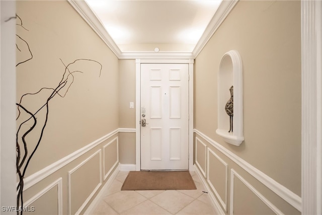 doorway featuring light tile patterned floors and ornamental molding