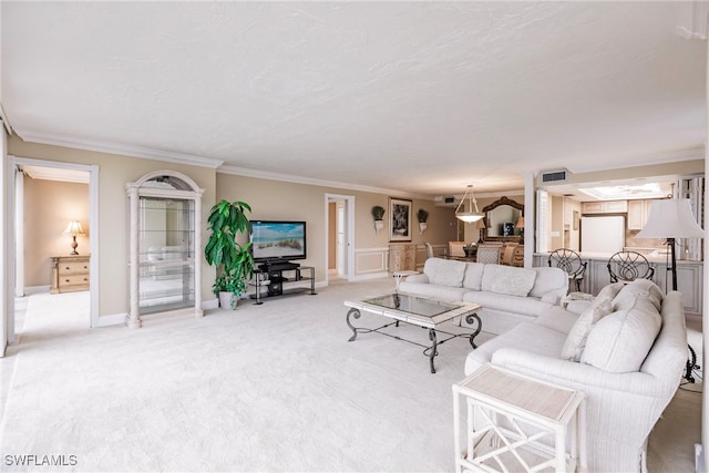 carpeted living room featuring ornamental molding