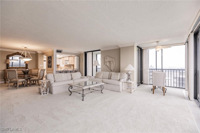 living room with light colored carpet, expansive windows, a textured ceiling, ornamental molding, and ceiling fan