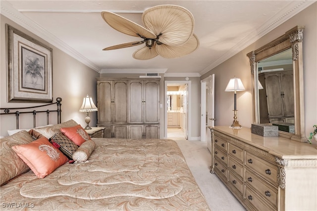 bedroom featuring ornamental molding, light colored carpet, ceiling fan, and ensuite bath