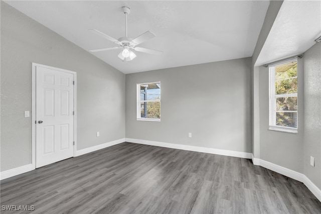 empty room featuring lofted ceiling, ceiling fan, and dark hardwood / wood-style flooring