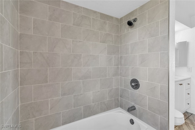 full bathroom with vanity, toilet, and tiled shower / bath combo