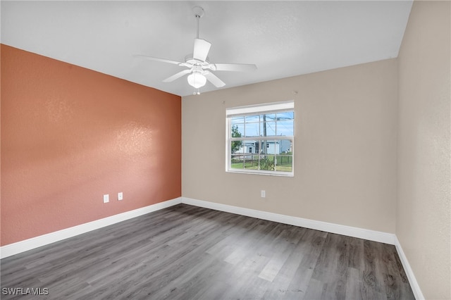 spare room featuring ceiling fan and dark hardwood / wood-style floors