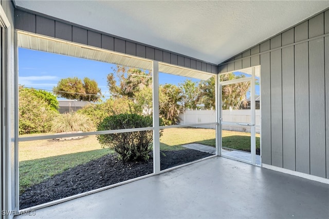 unfurnished sunroom featuring vaulted ceiling