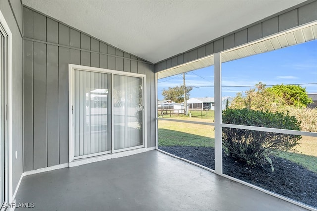 unfurnished sunroom featuring vaulted ceiling